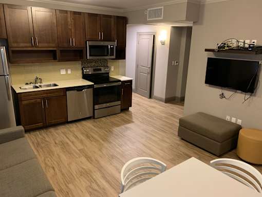 a kitchen and living room with a table and chairs