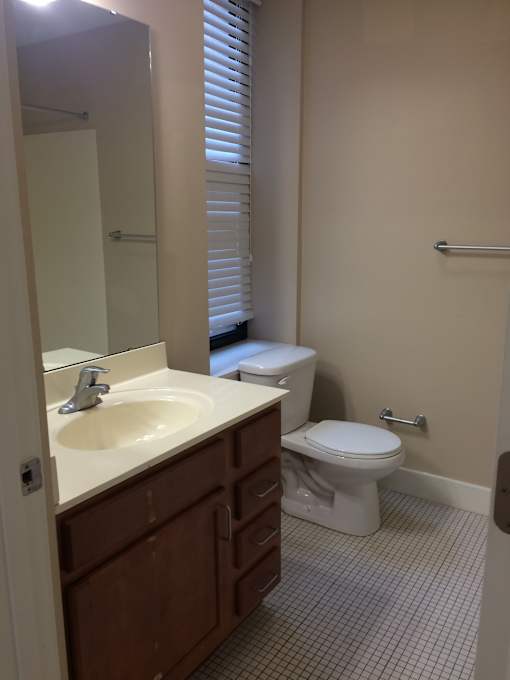 a small bathroom with a sink toilet and mirror