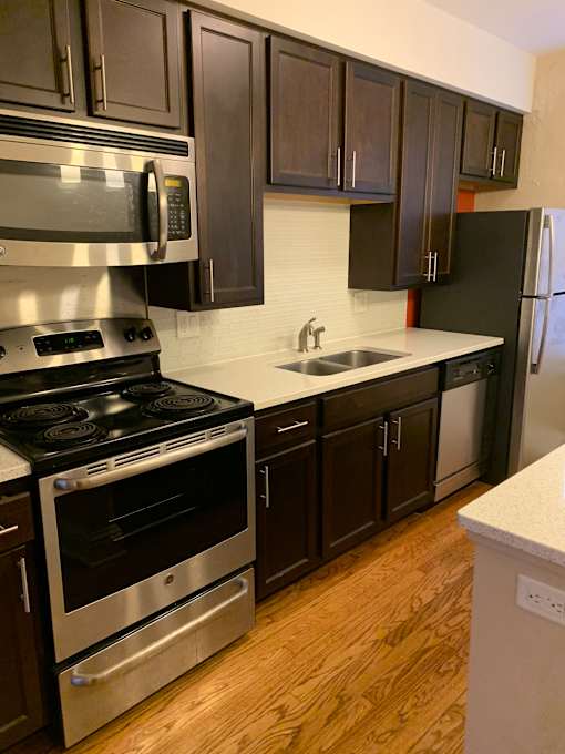 a kitchen with stainless steel appliances and black cabinets