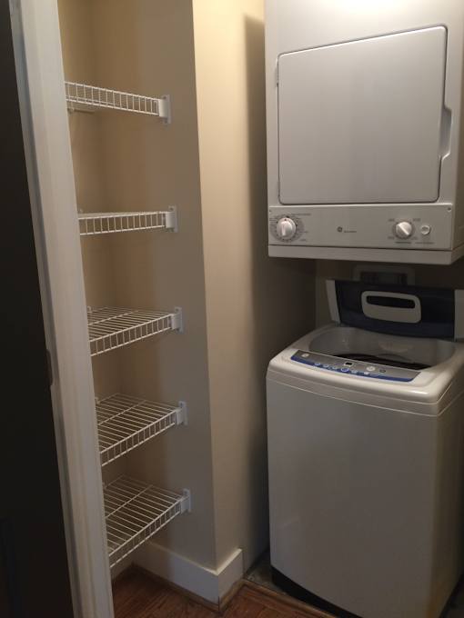 a small closet with a refrigerator and a washer and dryer