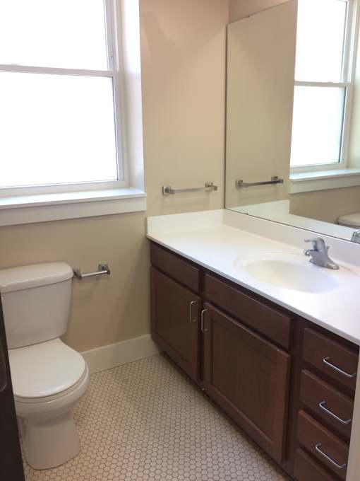 a bathroom with a toilet and a sink and a mirror
