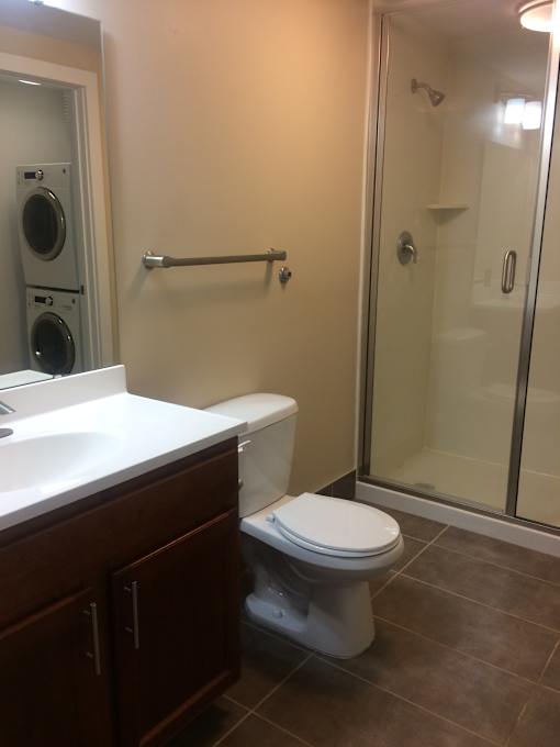 a bathroom with a toilet and a shower and a sink