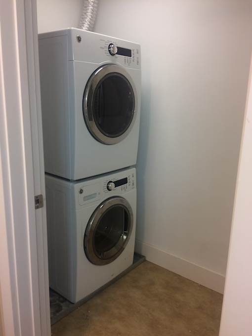 a front load washer and dryer in a laundry room