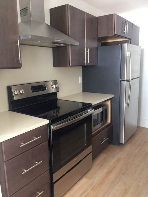 a kitchen with stainless steel appliances and wooden cabinets