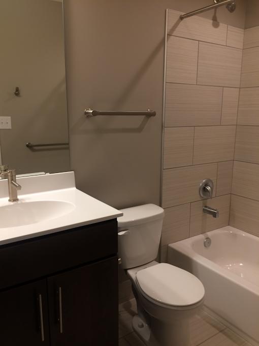 a small bathroom with a sink toilet and shower