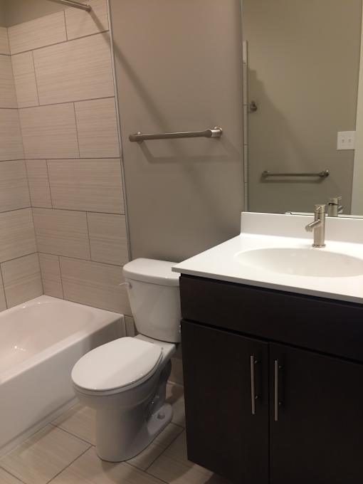 a small bathroom with a sink toilet and shower