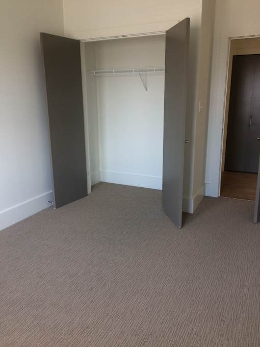 an empty room with a closet and a door