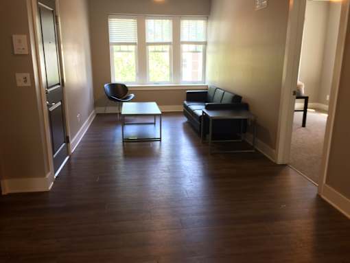 an empty living room with a couch and a table