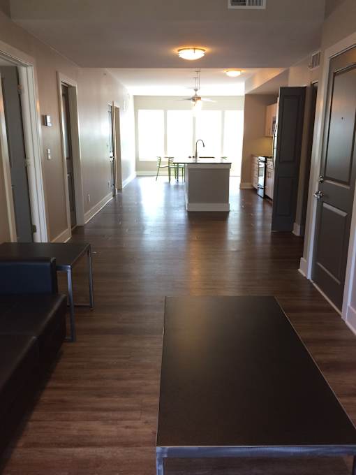 a view from the living room into the kitchen and dining room