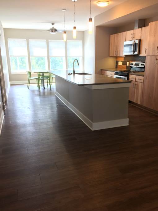 an empty kitchen with a large island in the middle of it