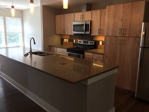 a kitchen with wooden cabinets and a counter top