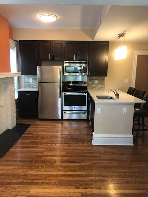 a kitchen with stainless steel appliances and black cabinets