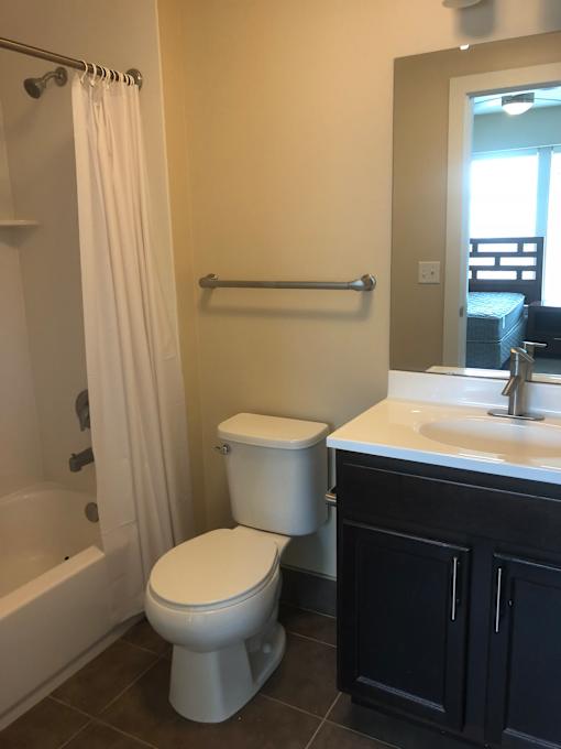 a bathroom with a toilet and a sink and a shower
