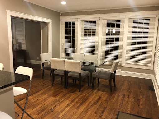 a dining room with a glass table and chairs