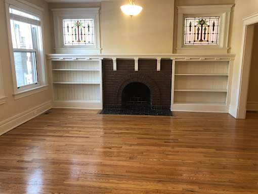 the living room with the fireplace and book shelves