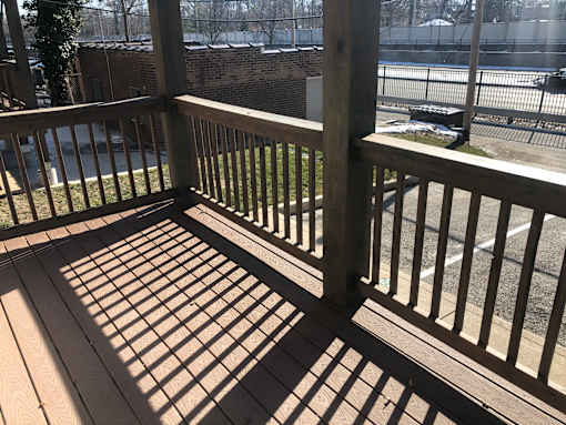 a view of a deck from a porch with shadows on it