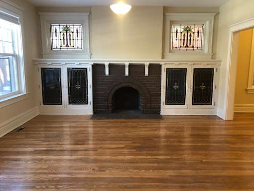 a living room with a fireplace and a wooden floor