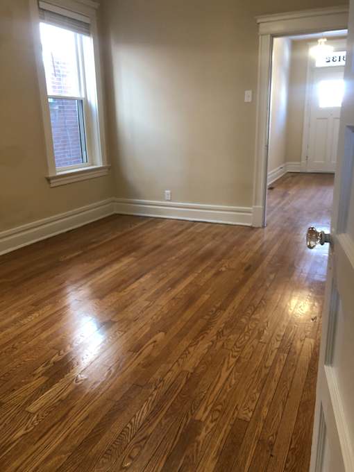 an overhead view of a hallway with wood flooring and a window