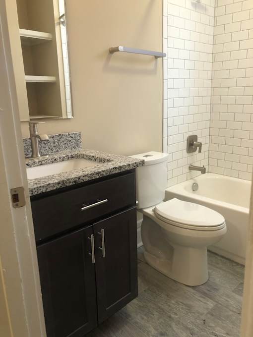 a bathroom with a toilet and a sink and a bath tub