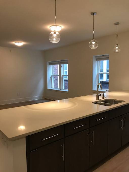 an empty kitchen with a sink and a window