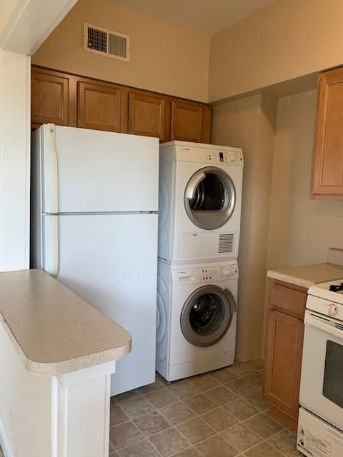 a kitchen with a washing machine and a refrigerator