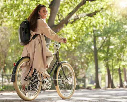 a woman riding a bike in a park