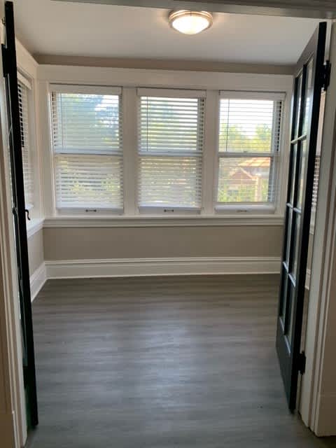 a empty room with four windows and a door