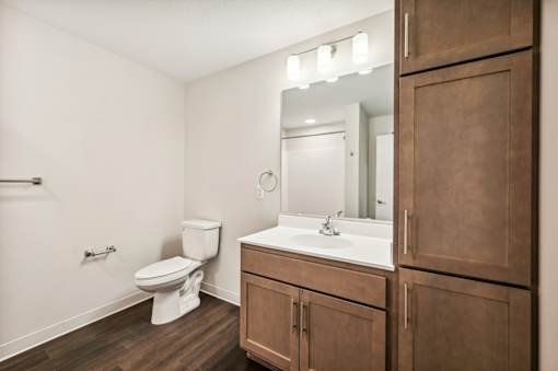 a bathroom with a sink toilet and a mirror