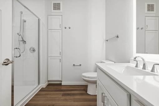 a bathroom with a toilet and a sink and a shower