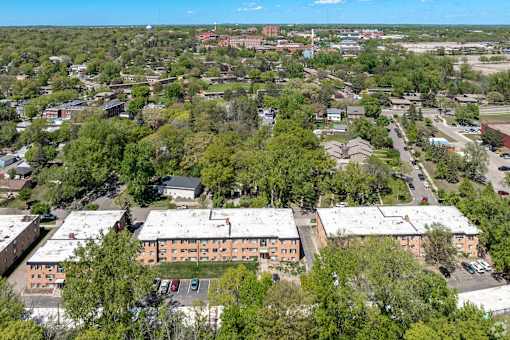 A bird's eye view of a residential area with apartment buildings and trees.