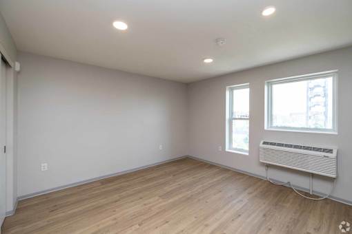 A room with a window and a radiator on the wall.