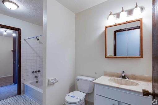 A white toilet with a blue label on it is in a bathroom.