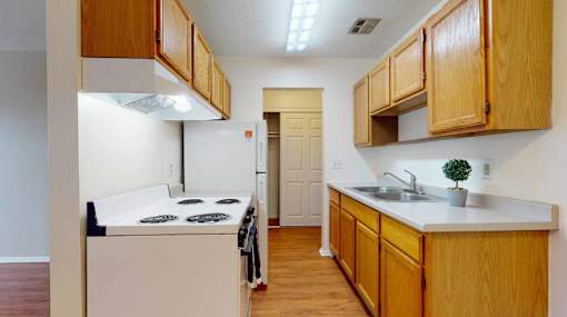 A kitchen with wooden cabinets and a white countertop.