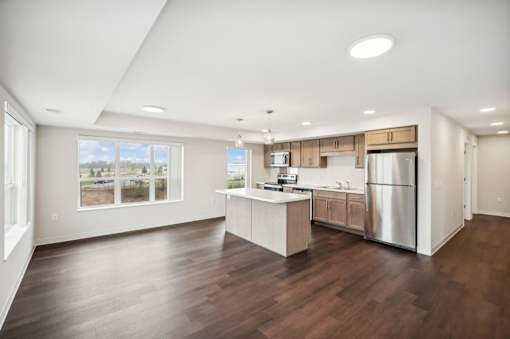 the preserve at ballantyne commons spacious living room and kitchen with stainless steel appliances