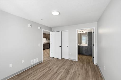A room with a white wall and a wooden floor.