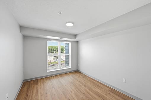 A room with a window overlooking a street.
