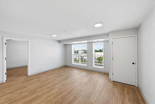 A room with wooden floors and white walls.