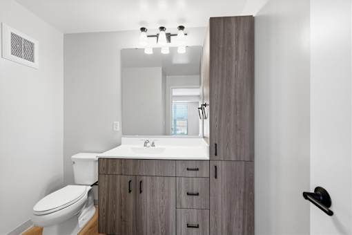 A bathroom with a white sink and a toilet.