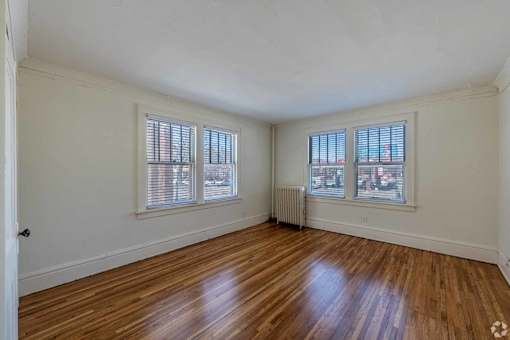 A room with wooden floors and white walls.