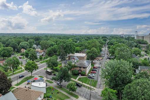 A view of a residential area with houses and trees.