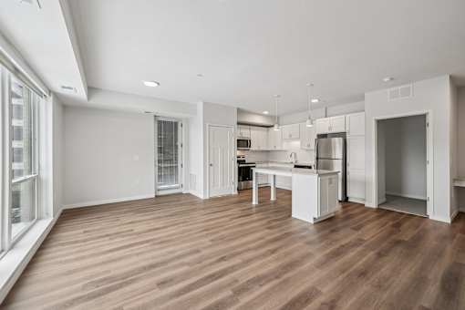 A kitchen with a refrigerator, sink, and cabinets is shown.