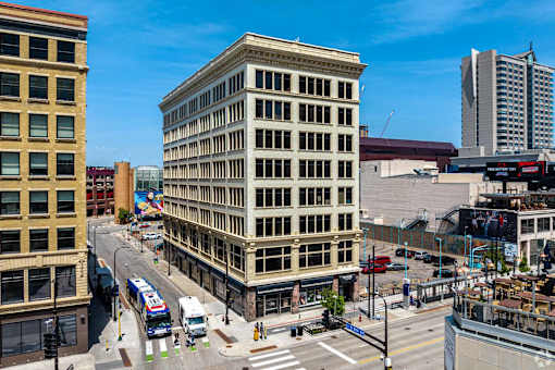 A city street with a large building in the middle.