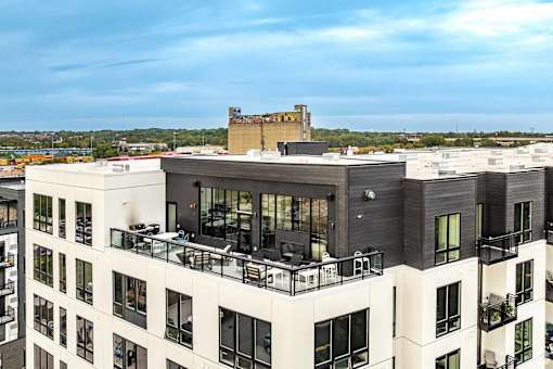 a view of a building with a balcony and a city in the background