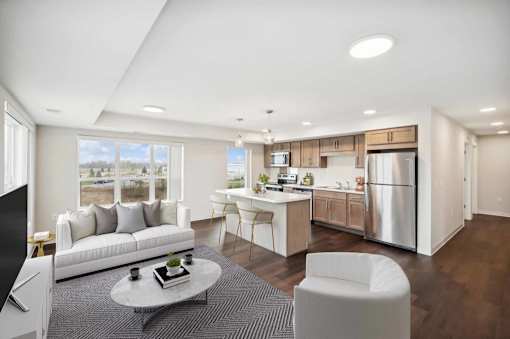 a living room and kitchen with a couch and a table