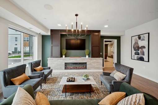 a living room with couches and chairs and a fireplace