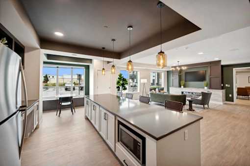 a large kitchen with a center island and a living room