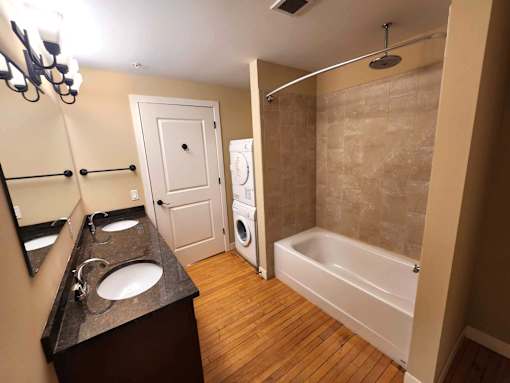 a bathroom with a sink and a tub and a washing machine