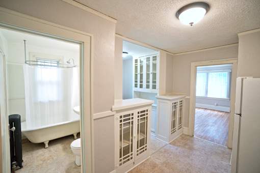 A white bathroom with a toilet, sink, and bathtub.
