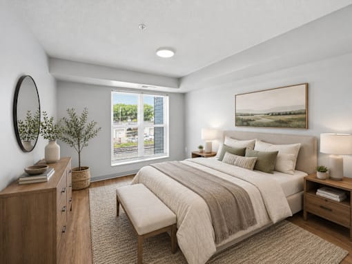 A bedroom with a large bed, a bench, and a painting on the wall.