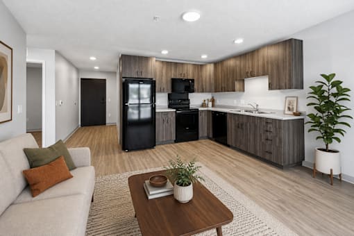 A modern kitchen with dark wood cabinets and a black refrigerator.